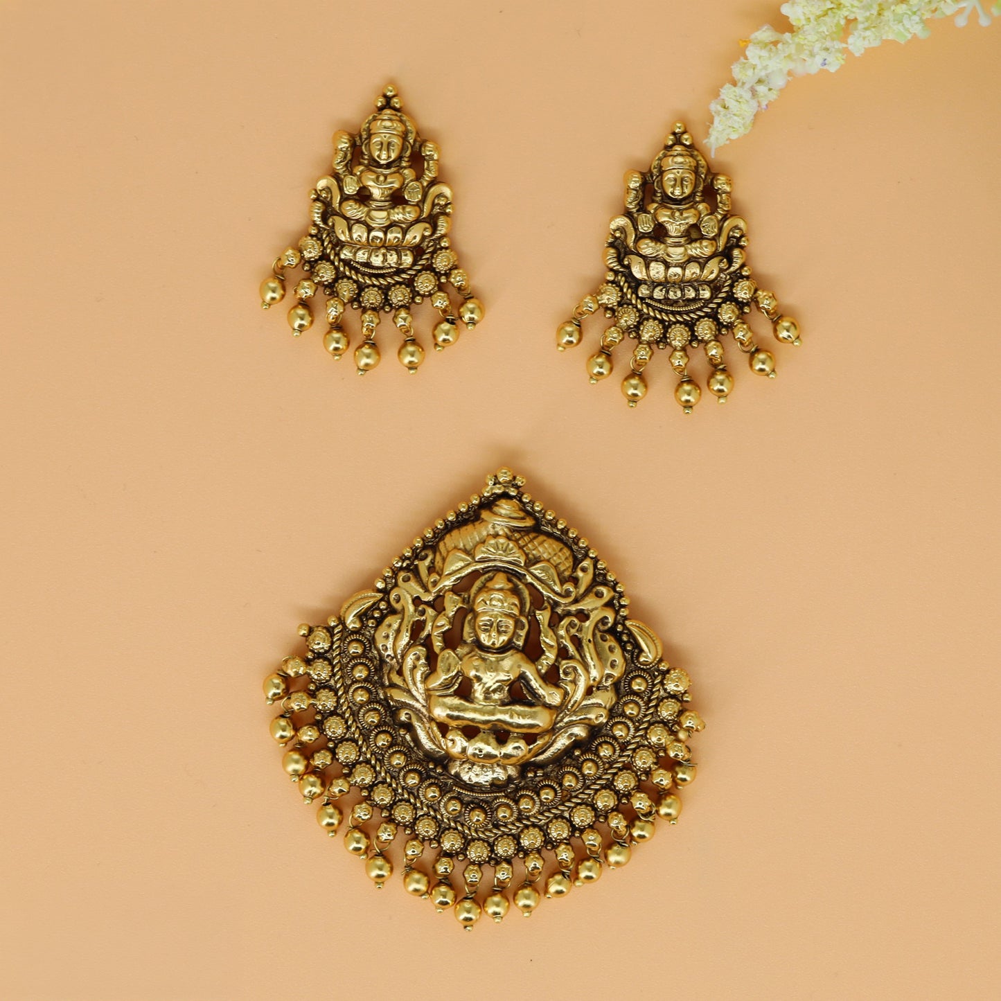 Antique pendant set with Lakshmi centre and finely detailed sculpted work