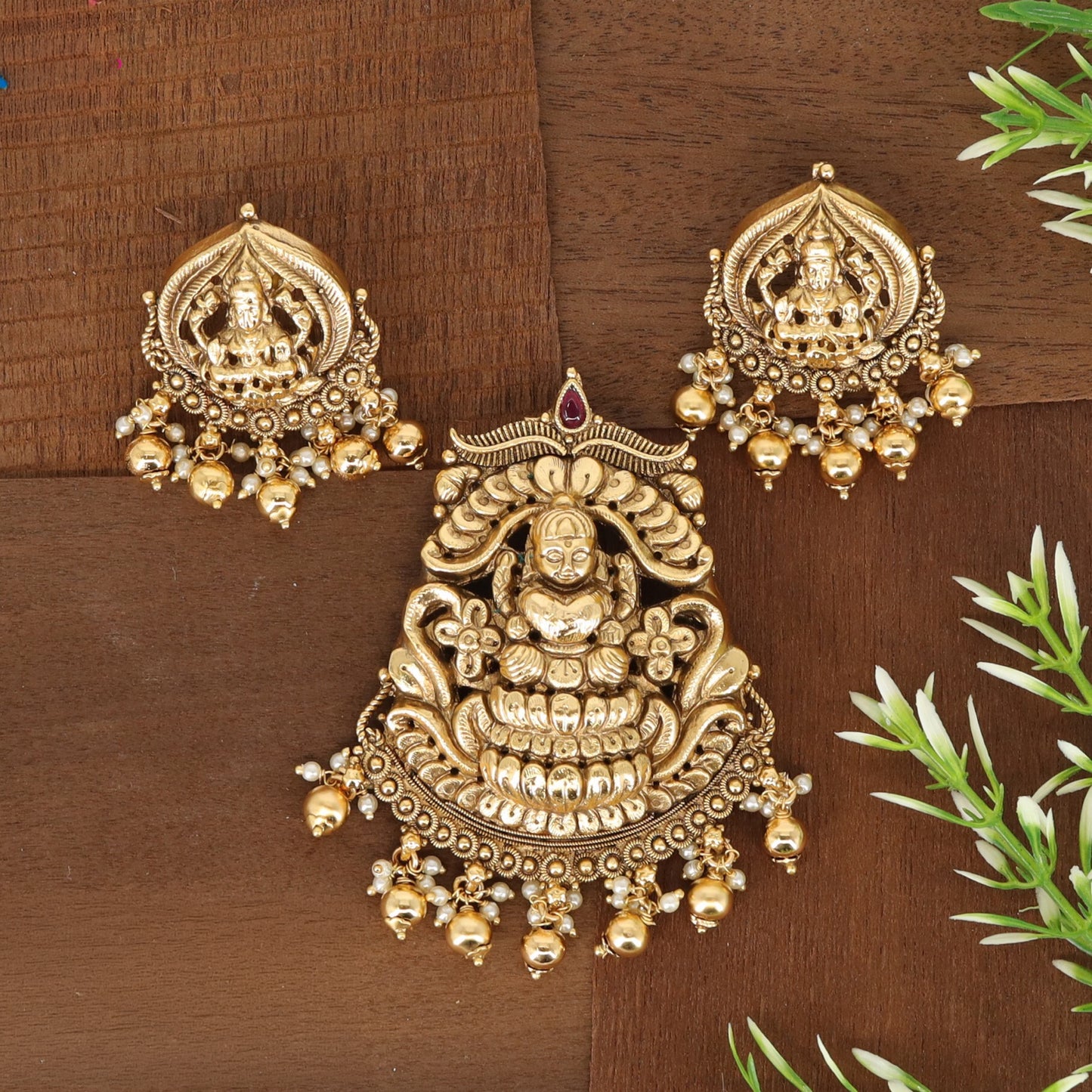 Traditional Lakshmi pendant set with sculpted goddess work and decorative drops