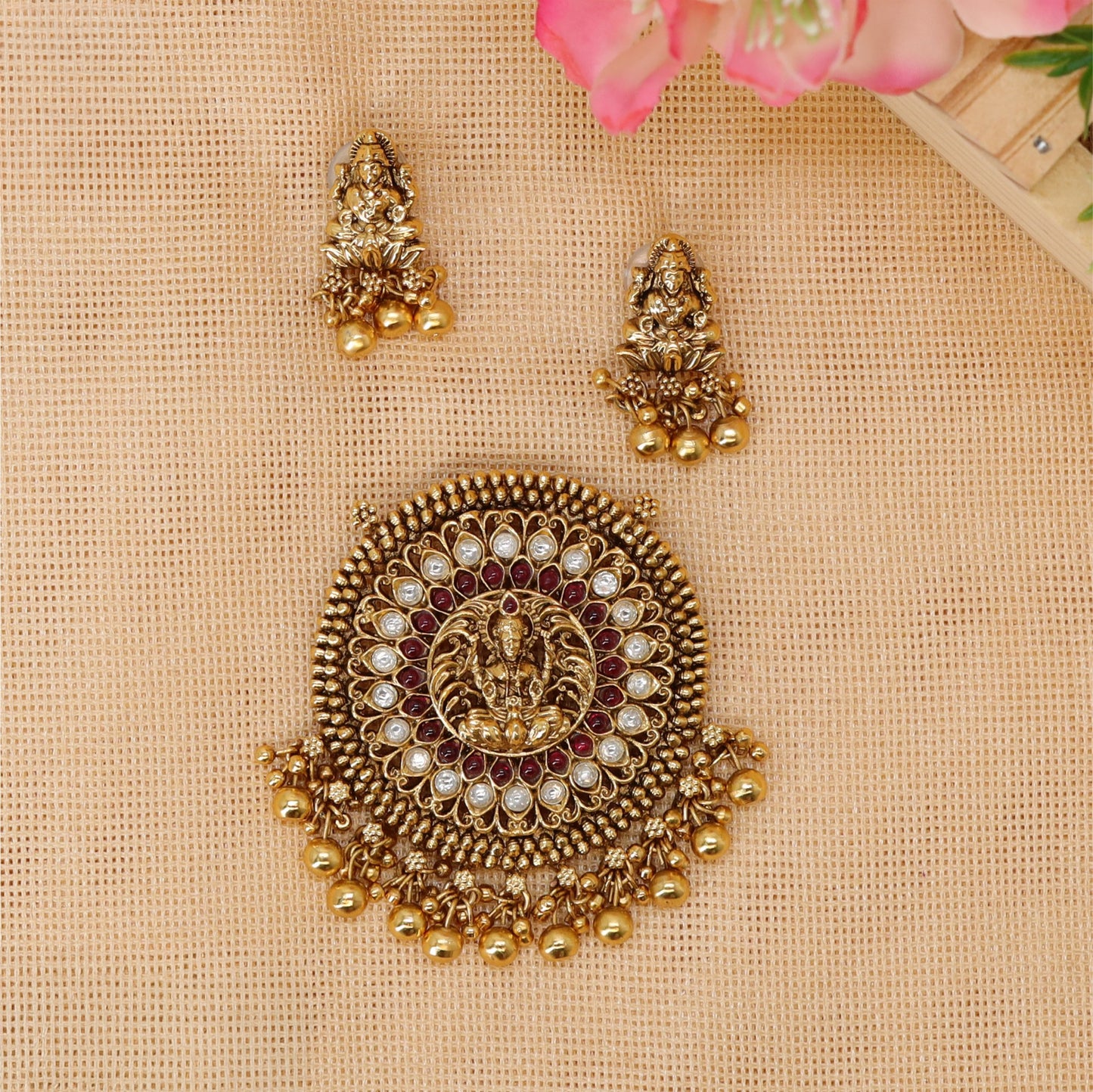 Antique pendant set with central Lakshmi and elaborate circular detailing