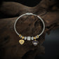 Playful Charm Bracelet with Cable Wire Band and Hanging Heart Eye Pendants