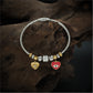 Playful Charm Bracelet with Cable Wire Band and Hanging Heart Eye Pendants