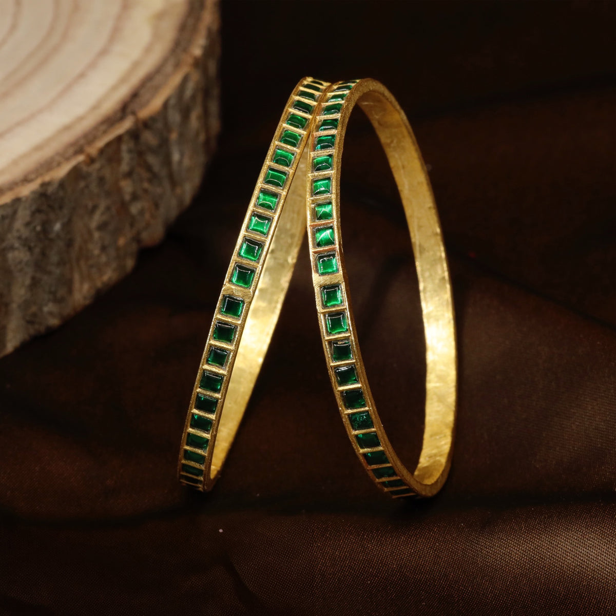 Classic Jadau bangles with geometric stone detailing and a polished heritage look