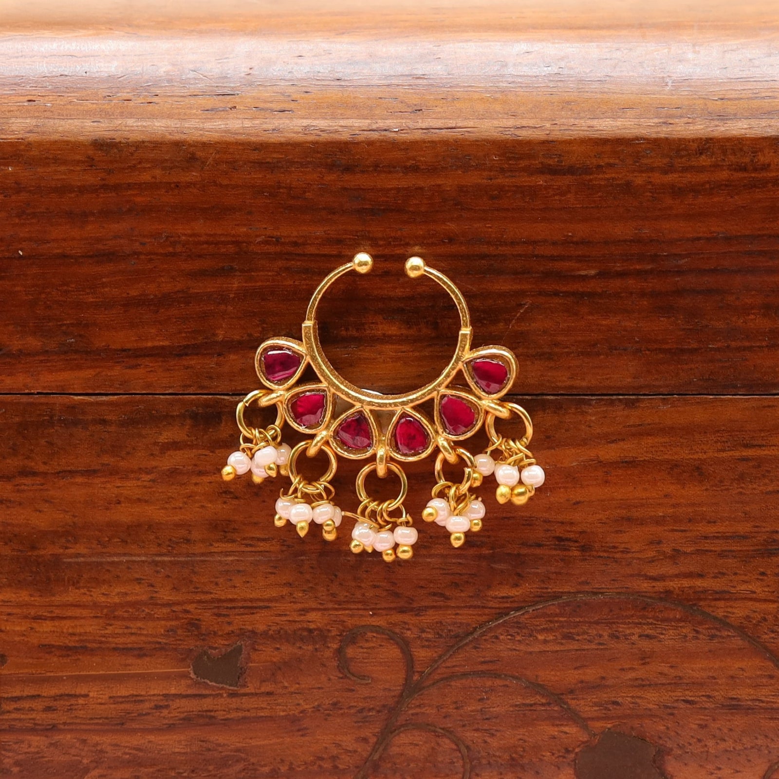 Decorative arc bugadi with spaced stone segments and ring drop details