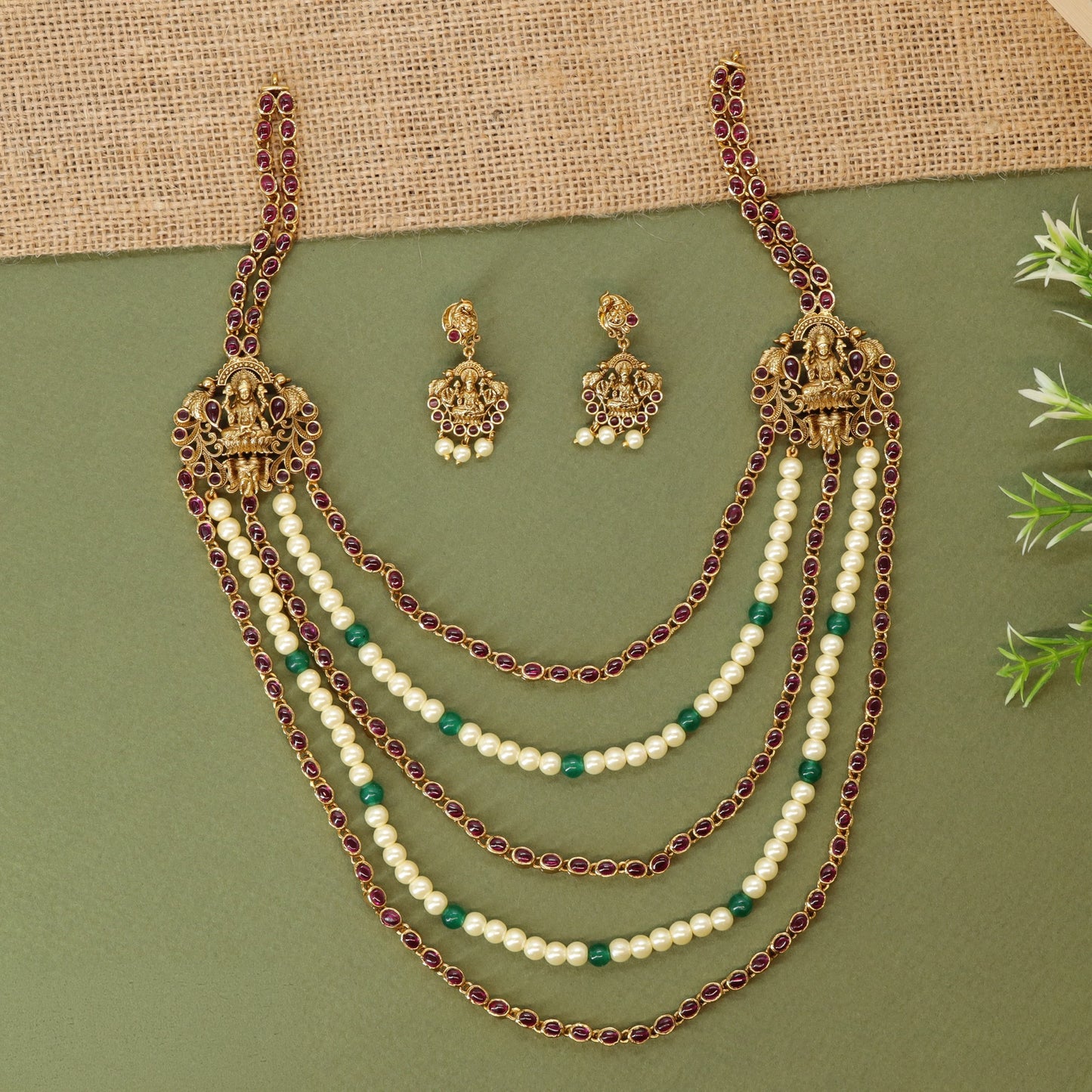 Antique long haara featuring framed goddess Lakshmi elements and graduated pearl strands