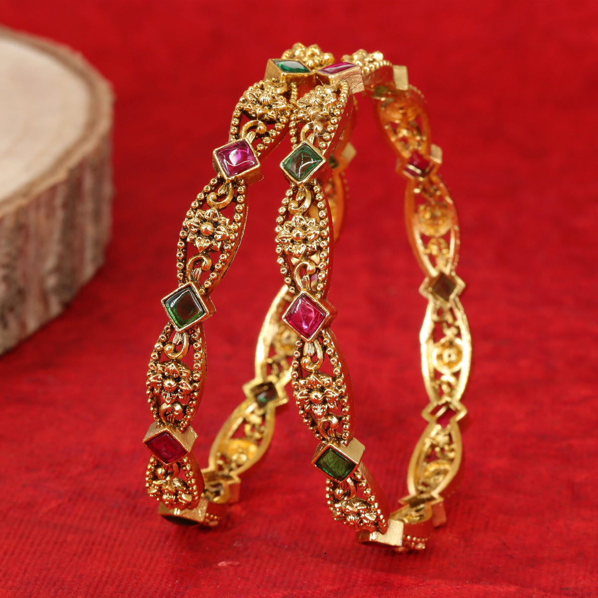 Antique bangles with intricate floral detailing and square accents