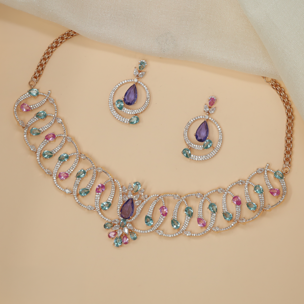 Rose gold crystal necklace with an artistic sequence of interlocking loops