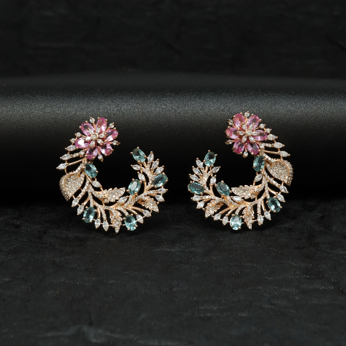 Rose gold floral studs with a distinctive curved profile