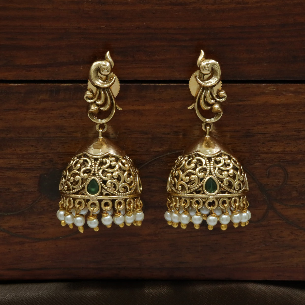 Temple Style Antique Jumka Earrings With Green Stone Embellishments