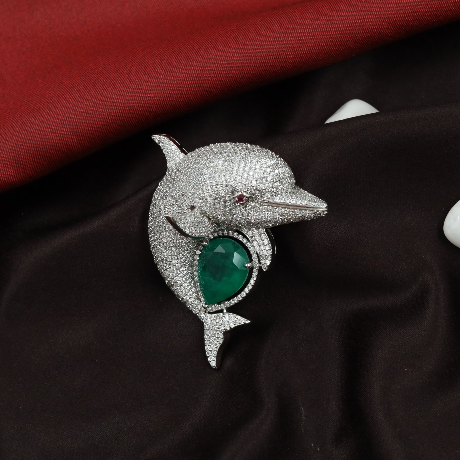 Ocean Curve Dolphin Silhouette Rhodium Brooch with Emerald Core