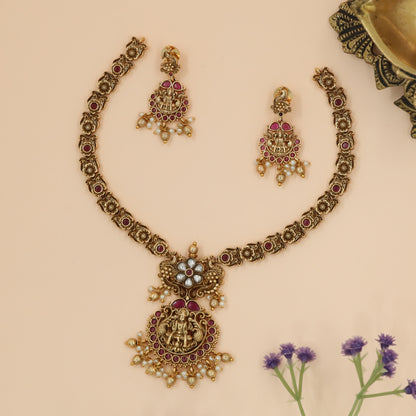 Divine Lakshmi Medallion Necklace with Floral Kundan Crest and Ruby Halo