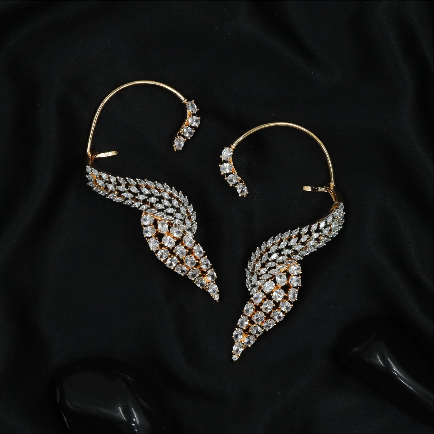 Feather curve Ear bluetooth with sweeping form and dense stone arrangement