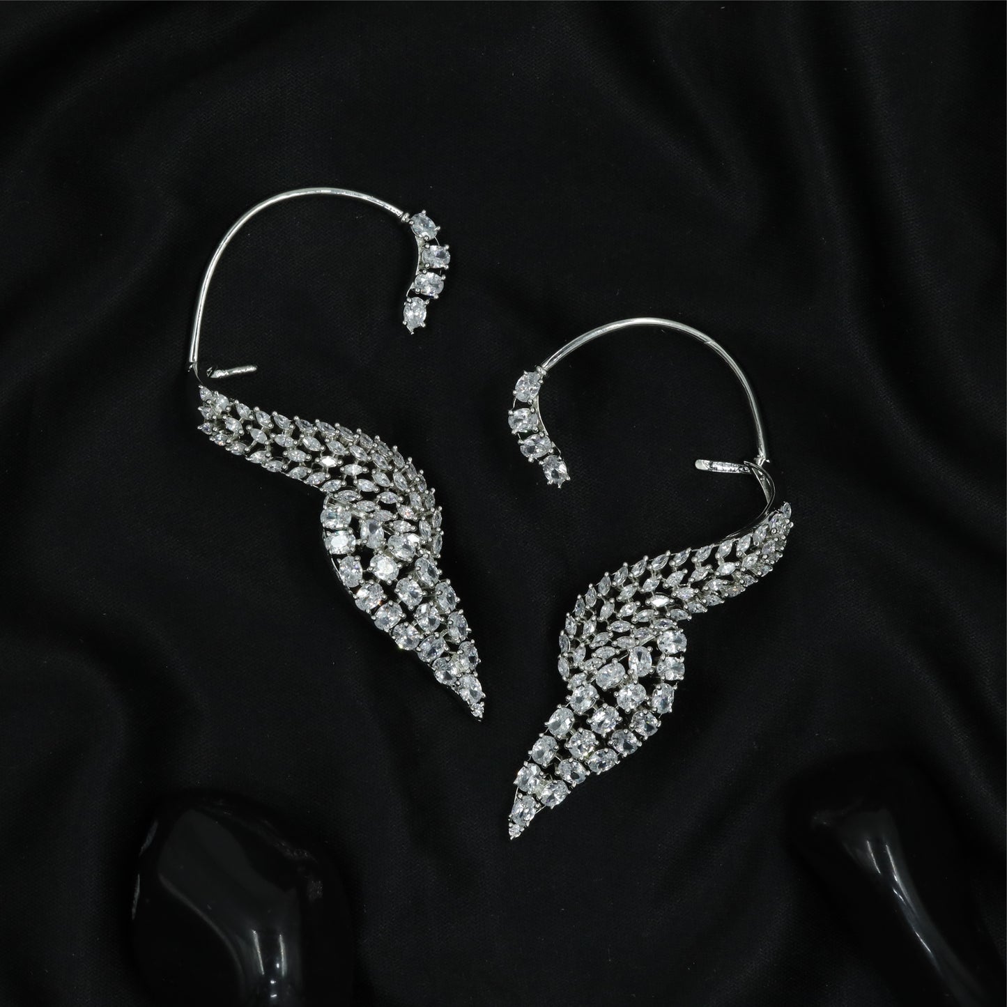 Feather curve Ear bluetooth with sweeping form and dense stone arrangement