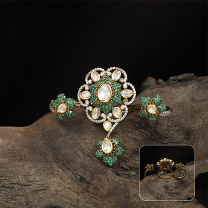 Connected floral kundan finger ring with central cluster and side petal forms with hanging drop
