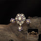 Connected floral kundan finger ring with central cluster and side petal forms with hanging drop