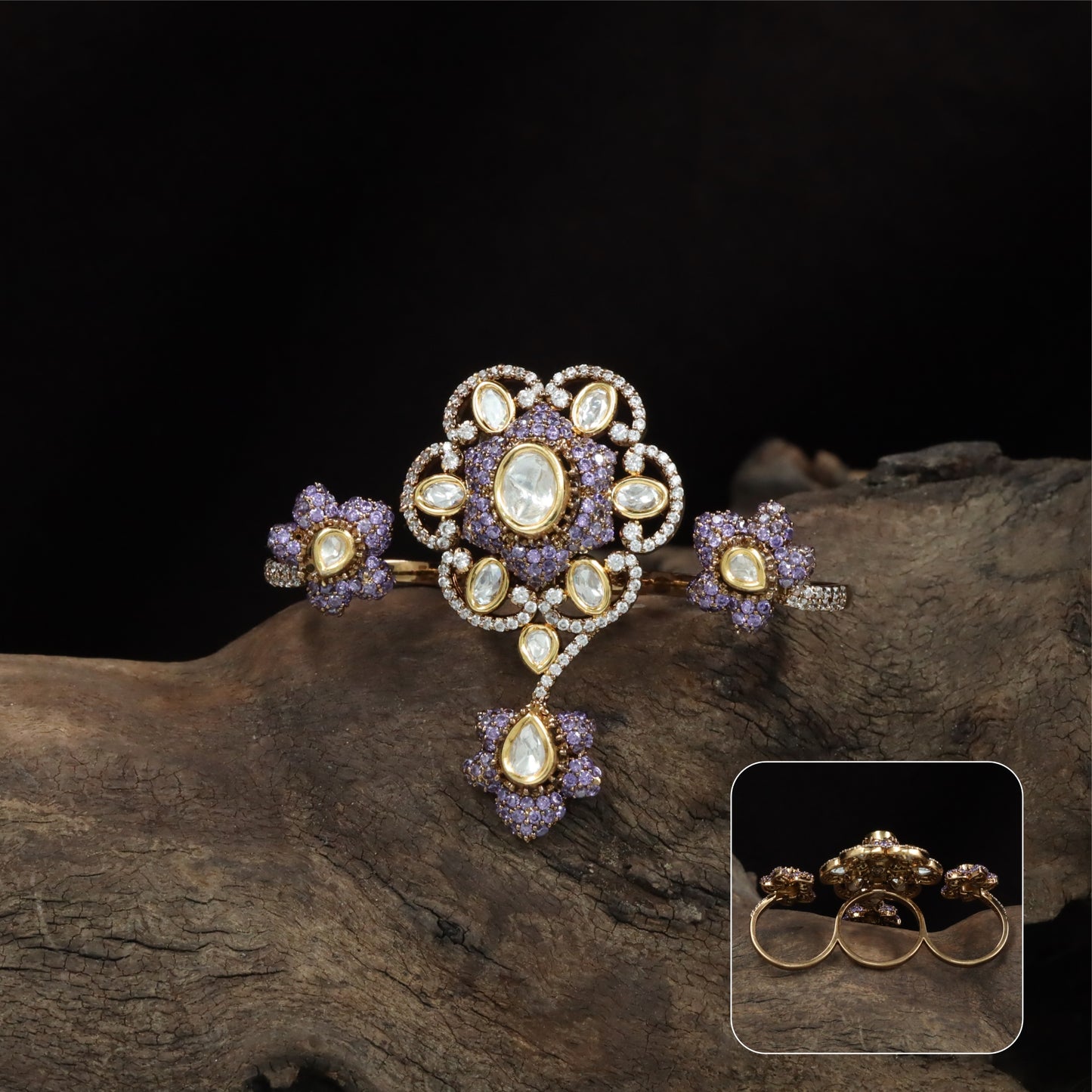Connected floral kundan finger ring with central cluster and side petal forms with hanging drop