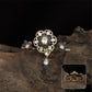 Connected floral kundan finger ring with central cluster and side petal forms with hanging drop