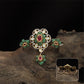 Connected floral kundan finger ring with central cluster and side petal forms with hanging drop