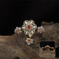 Connected floral kundan finger ring with central cluster and side petal forms with hanging drop