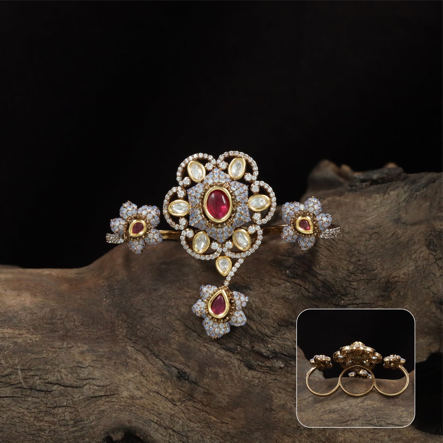 Connected floral kundan finger ring with central cluster and side petal forms with hanging drop