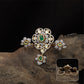 Connected floral kundan finger ring with central cluster and side petal forms with hanging drop
