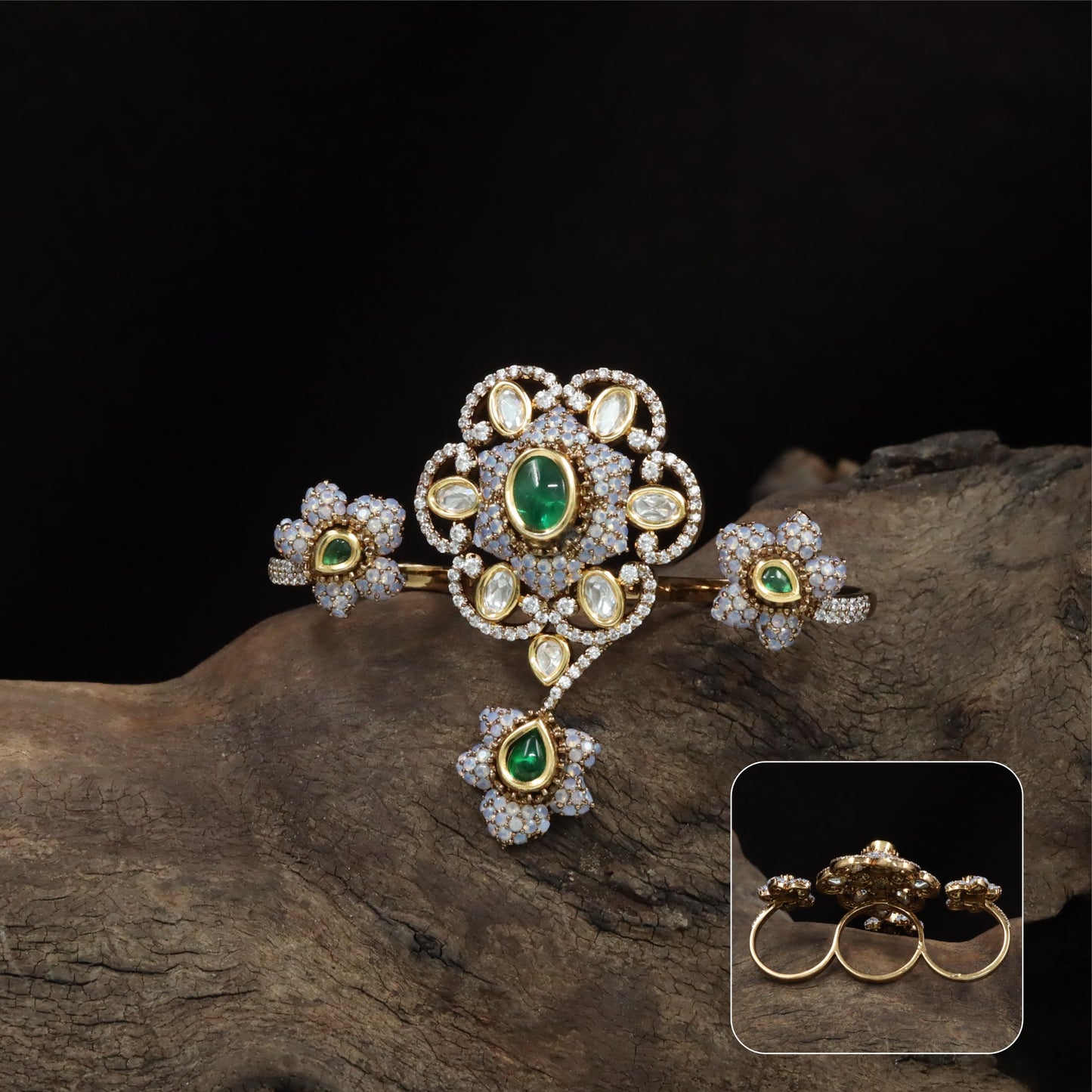 Connected floral kundan finger ring with central cluster and side petal forms with hanging drop