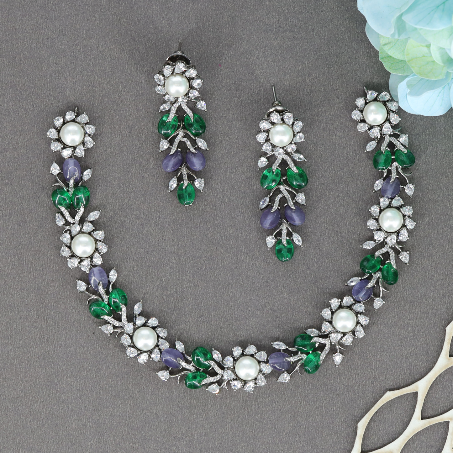 Midnight Finish Floral Cluster Necklace with Leaf Motif Detailing and Matching Drop Earrings