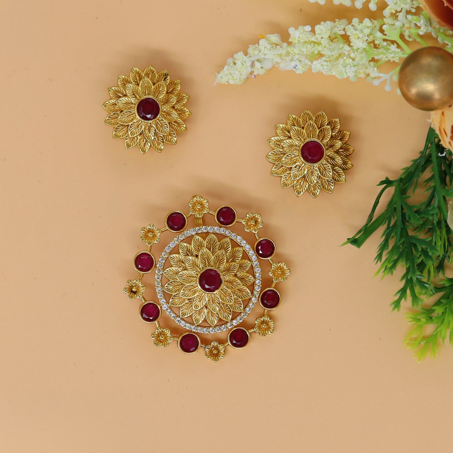 Antique floral pendant set with sculpted leaf petals and circular detailing